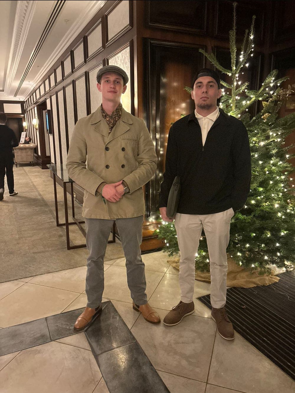 Daniel and his then co-founder Max in a London hotel lobby beside a Christmas tree